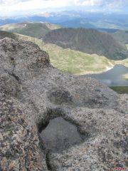 A pool of water summit lake and Saint Marys Glacier 