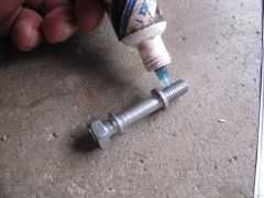 I used Honda thread lock on the spring hook bolt