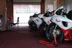 Some Ducati's sharing a garage with a BMW