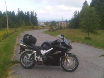 My bike with Foymount in the background - Foymount hosts an abandoned Cold War radar station, and boasts the highest inhabited point in Ontario (484m above sea level according to my GPS app....)