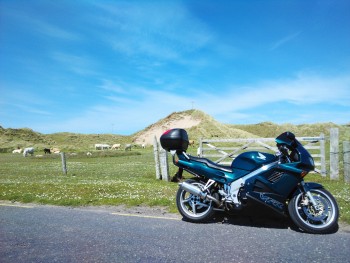 Blue sky, sand dunes, and a green RC36